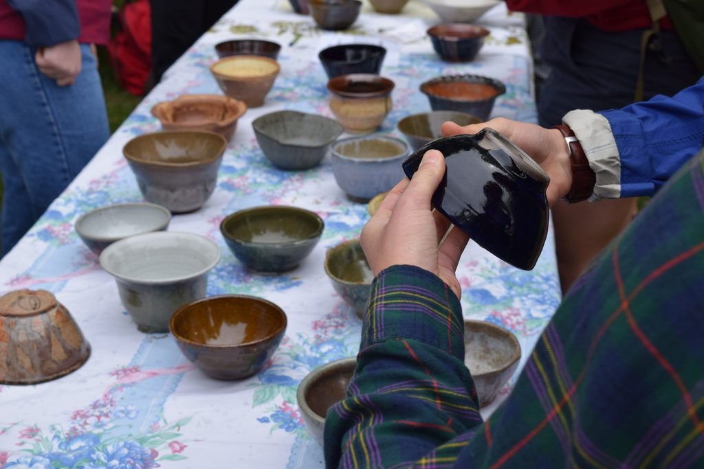 Hands Selecting a Bowl at the Empty Bowls Event