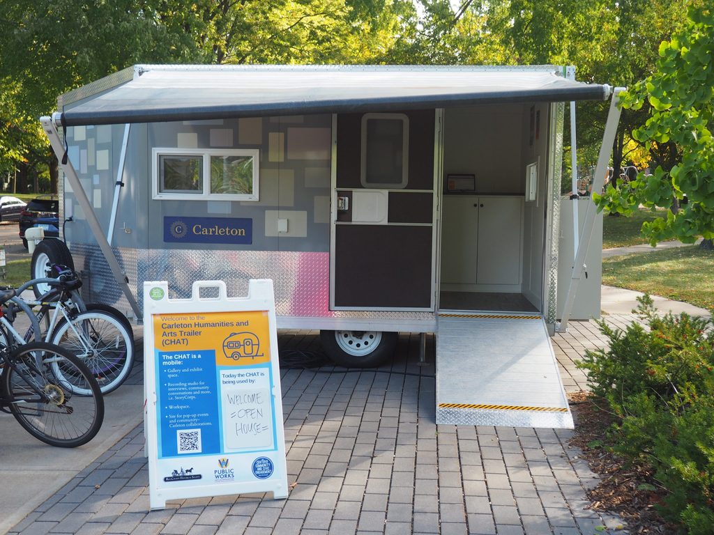 a small silver trailer with an info sign