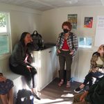 4 people sit in a circle inside the trailer