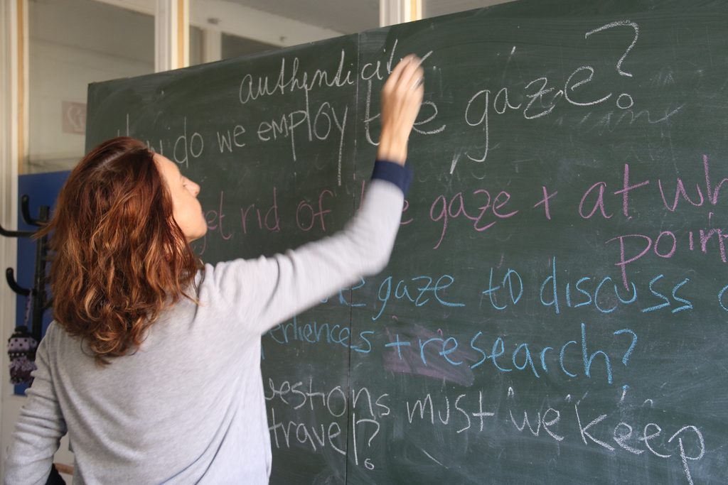 GWSS Professor Iveta Jusova writing on a chalkboard
