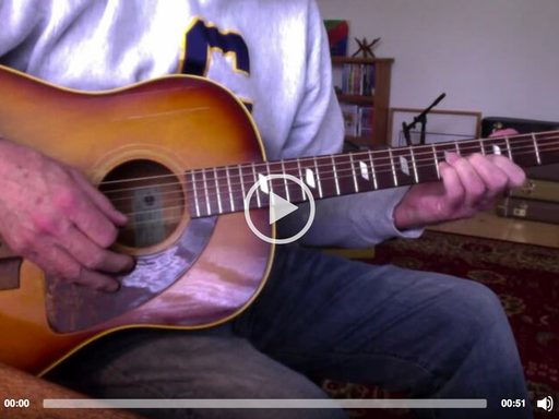 A man playing an acoustic guitar