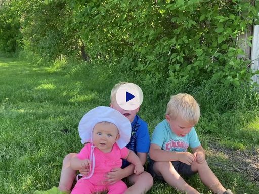 three little kids on a lawn