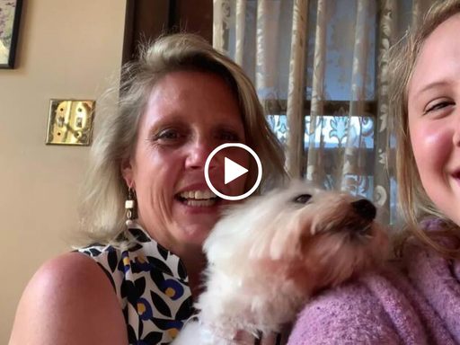 two women with a fluffy dog