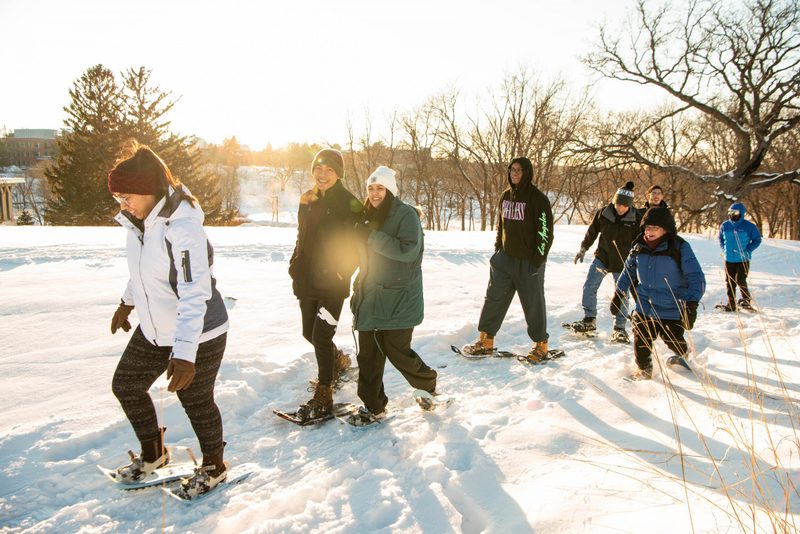 Students snowshoe in the arb