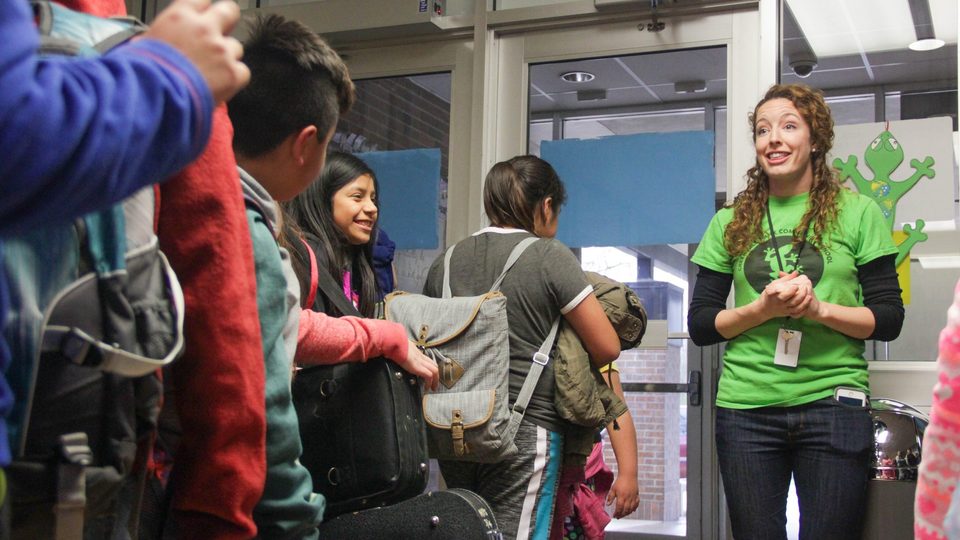 Kathryn Lozada '12 says goodbye to energized students after programming ends for the day.