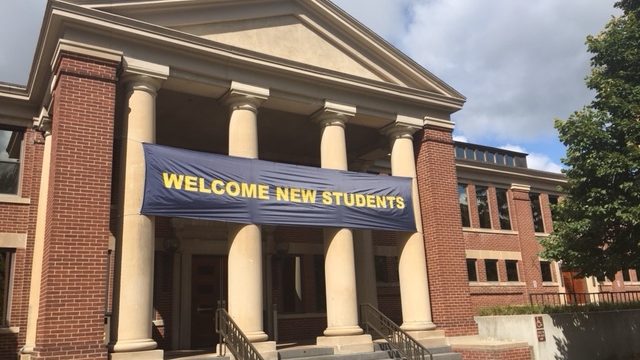 Image of the front of Sayles Hill Campus Center with a "Welcome New Students" banner.
