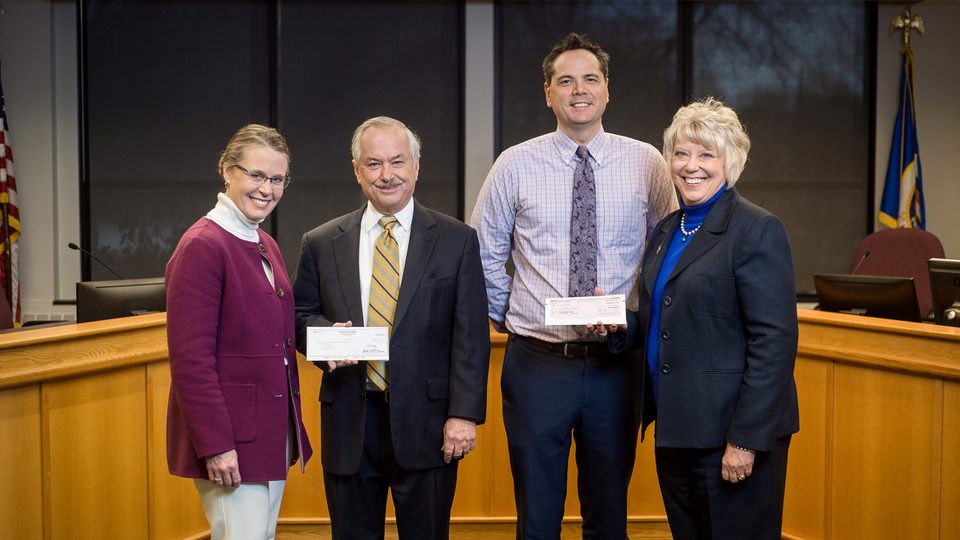 Image of donation checks being given to City of Northfield staff.