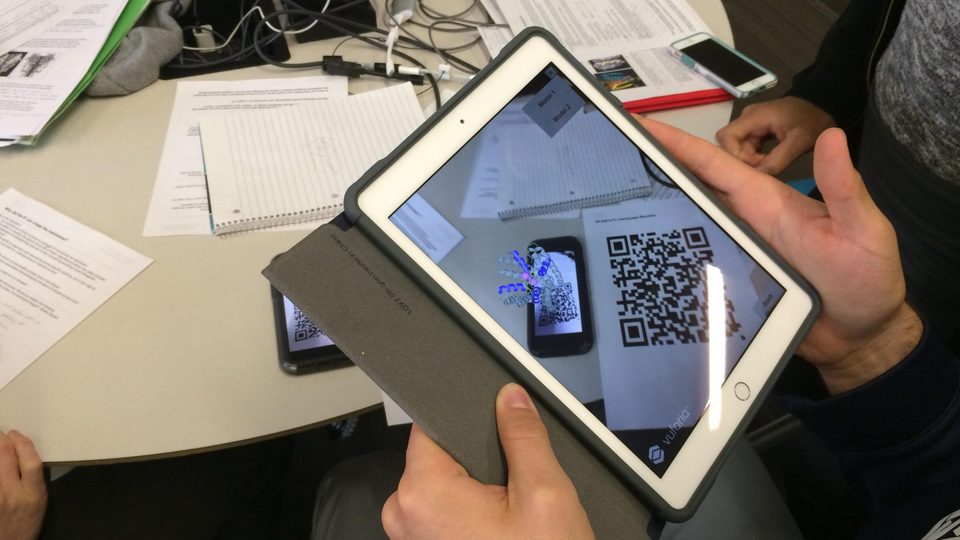 Image of a student using the BiochemAR app on an iPad.