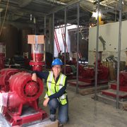 Martha Larson with a water pump in the new East Energy Station in the sub-basement of Anderson Hall.