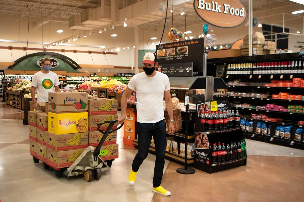 Associate professor Dan Groll and Jack Johnson ’21 transporting food at Cub Foods