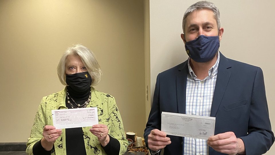 Carleton Vice President and Treasurer Eric Runestad and St. Olaf Vice President and Chief Financial Officer Janet Hanson present the colleges' annual donation to the City of Northfield