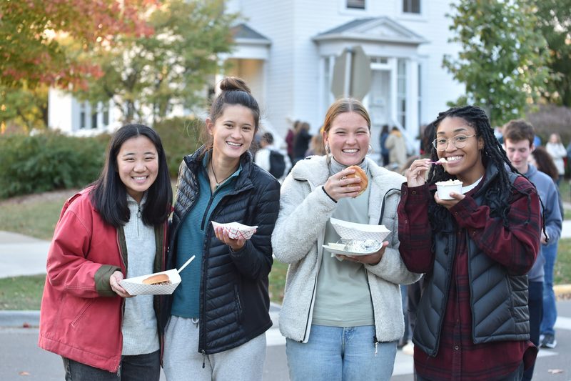 students eating at the street fair