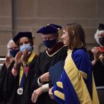Alison smiling towards the crowd as she receives applause after her installation.