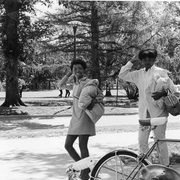Two college students are shown outside on a college campus in the 1960s.