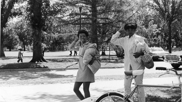Two college students are shown outside on a college campus in the 1960s.