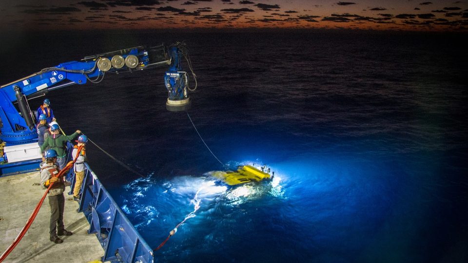 Scientists conduct deep sea research.