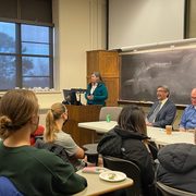 Students and professors sit together in a classroom.