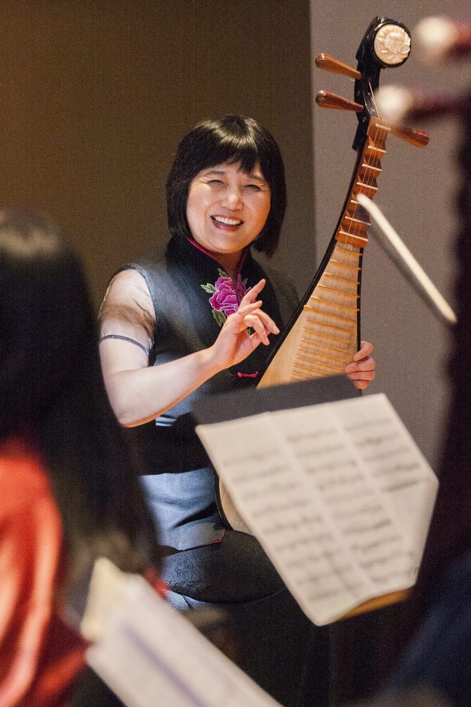 Gao Hong smiling and playing the pipa
