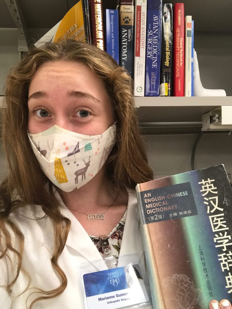 Headshot of Marianne Gunnarsson '22 holding a Chinese-English medical dictionary