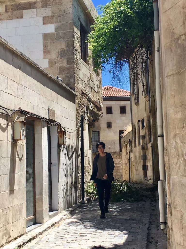 A selfie of Yuanhao Zou among the ancient buildings