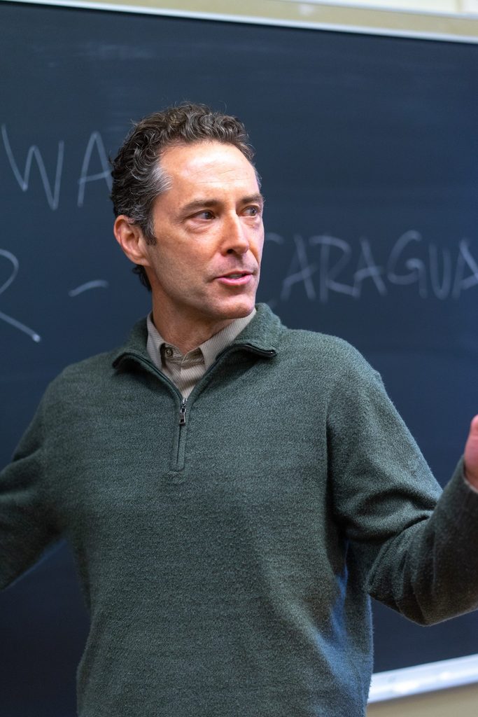 Candid portrait photo of Professor David Tompkins teaching