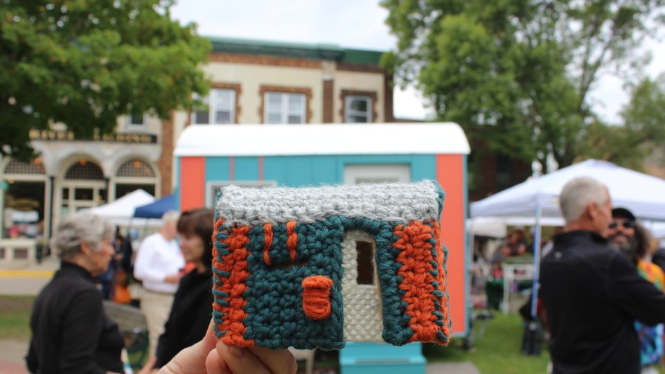 A person holds up a crotchet replica of Cecelia Cornejo's mobile art piece,