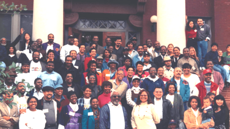 A large group of members from the Multicultural Alumni Network pose on the steps of Sayles in 1996.