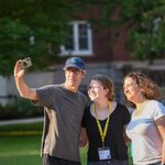 A student takes a selfie with their parents outside Burton.