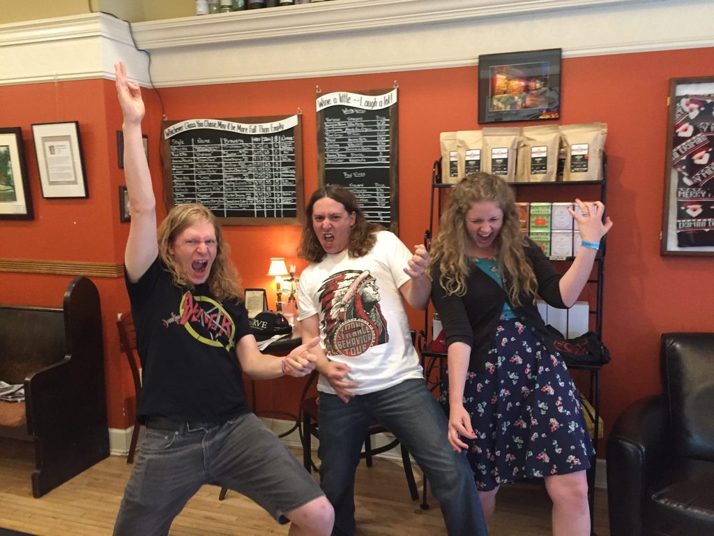 Rachel Sinclair '07, John Humphrey and Rob Nechanicky strike air guitar poses in the Hideaway Coffeehouse and Wine Bar.