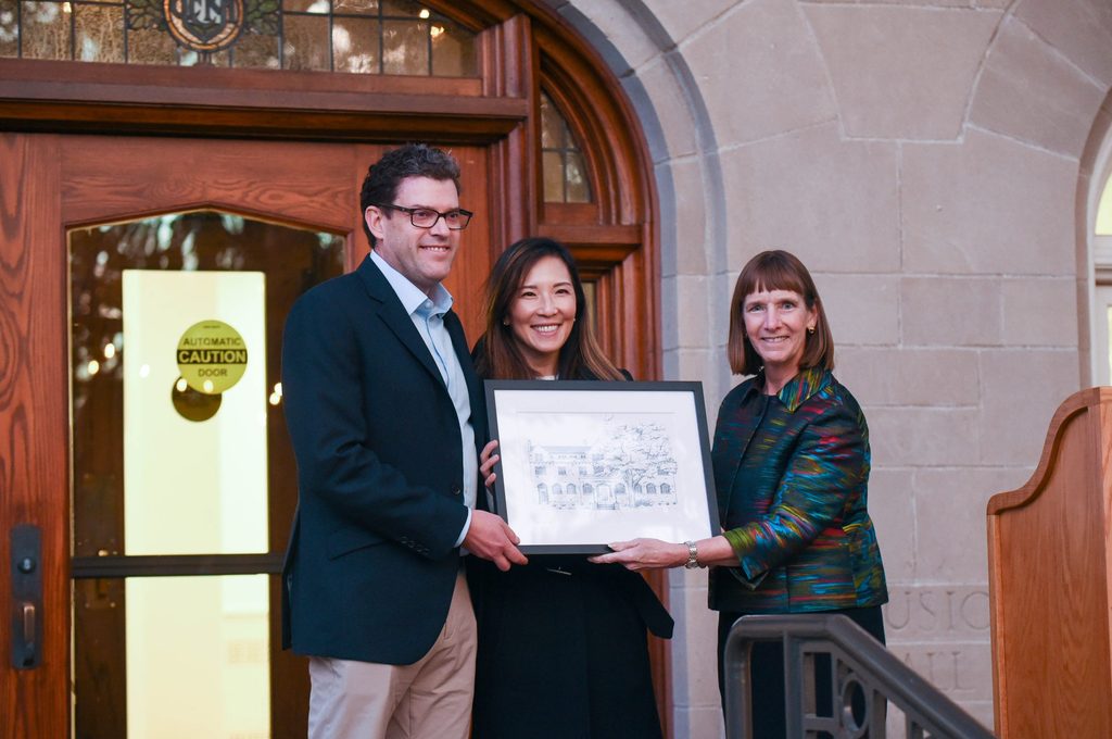 Michael and Mary Ann Hasenstab pose with President Byerly, all of them holding up a framed illustration of Hasenstab Hall.