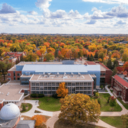 Aerial shot of campus with Olin Hall and the rest of the integrated science complex in the forefront. The trees are all orange, red and yellow.