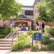 Students walk up the front steps and into the entrance of Johnson House.