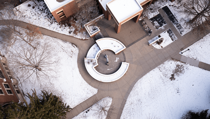 Aerial shot of the Founder's Court in front of the Libe, showing that the courtyard sculpture and bench form a letter C when seen from above.