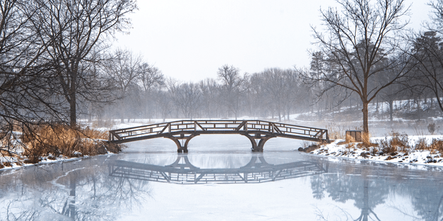 Wideshot of the bridge to Mai Fete across frozen Lyman Lakes, with a layer of fog over everything.
