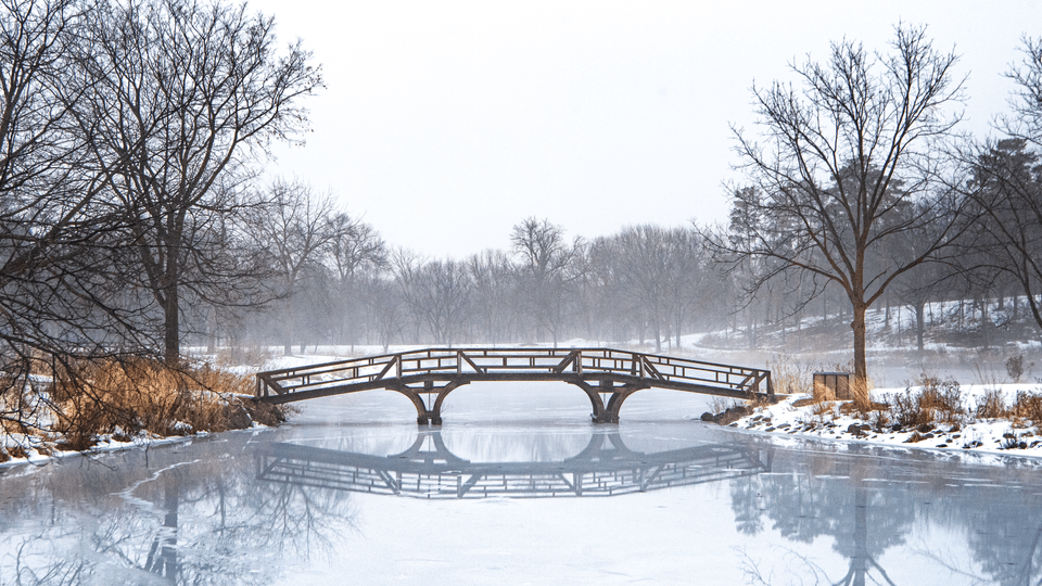 Wideshot of the bridge to Mai Fete across frozen Lyman Lakes, with a layer of fog over everything.