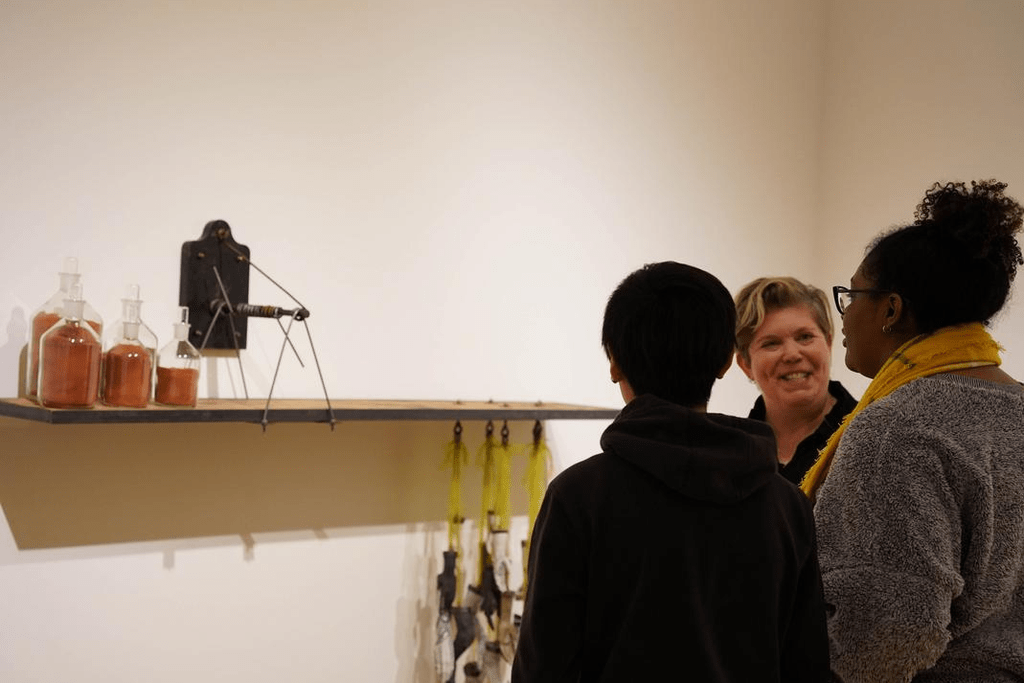 Students and faculty discussing art installment