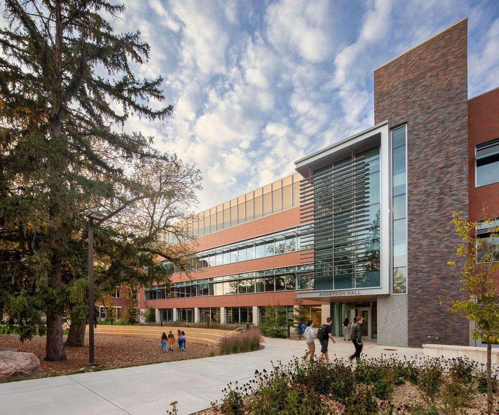 Wide-angle shot of the front of Anderson Hall, with students walking around.