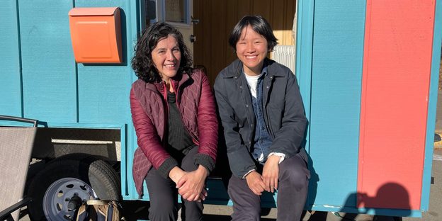 Cecilia Cornejo and Peixuan Ouyang ’18 sit on the steps of the Wandering House.