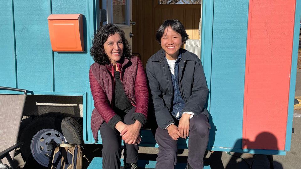 Cecilia Cornejo and Peixuan Ouyang ’18 sit on the steps of the Wandering House.