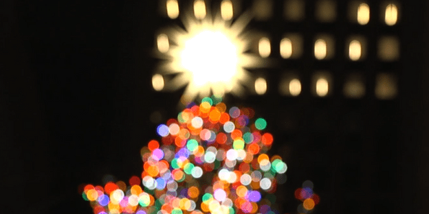 Out of focus image of a lit up Christmas tree