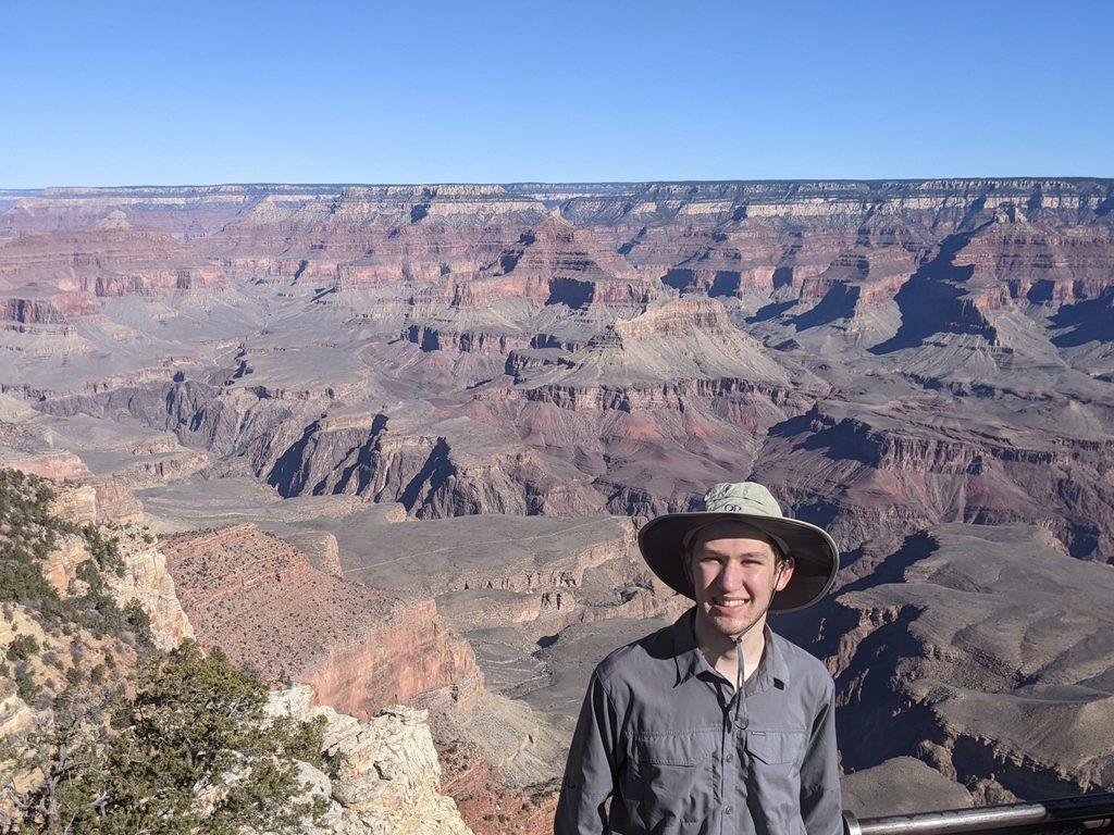 Oliver Tullio posing in front of the Grand Canyon.