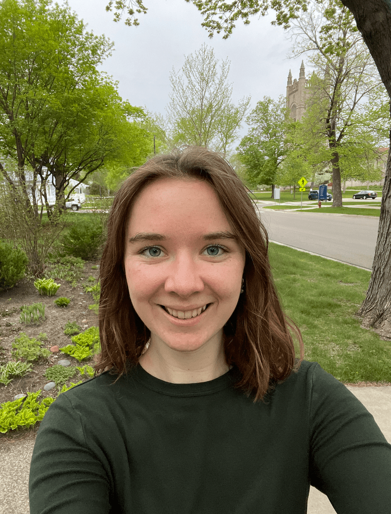 Natalie Bax, outside with the Chapel in the background.