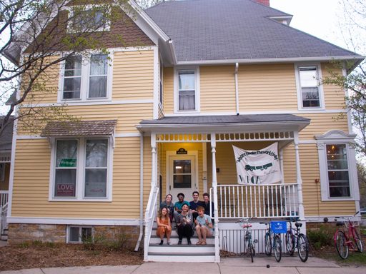 Students sitting on front steps of WHOA house.