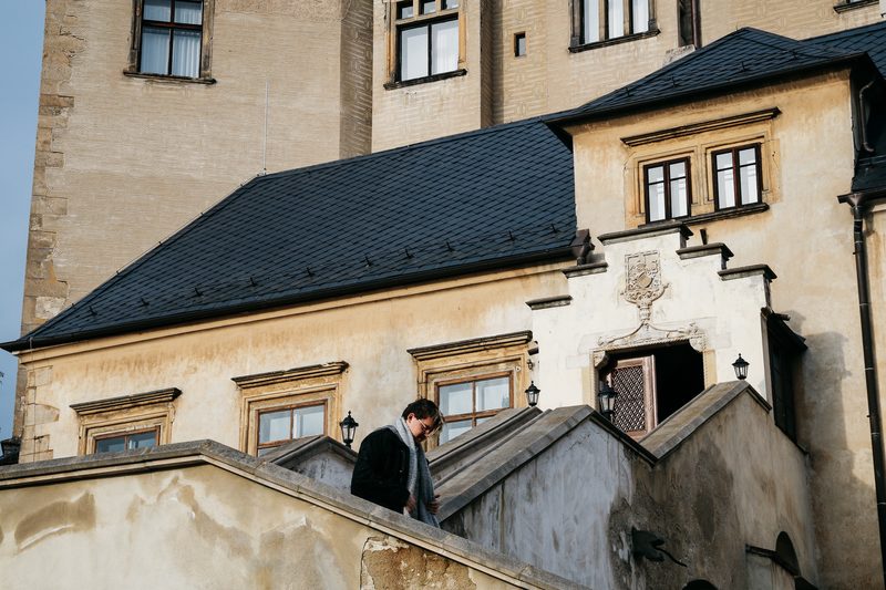 Student walking down the stair of an old European building