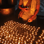 A student lights a candle