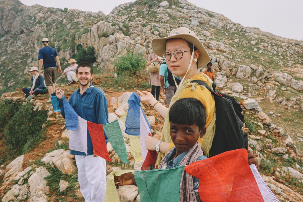 Students hold flags on a mountain top