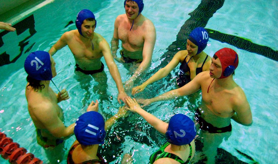 Team huddle in pool