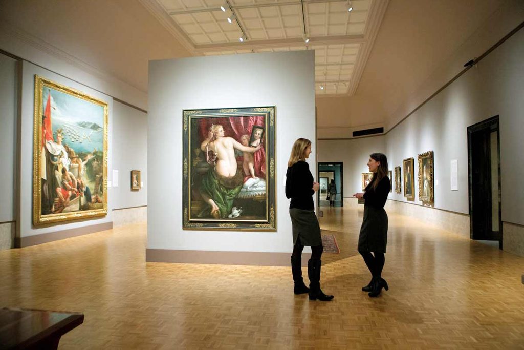 two women talking in a museum