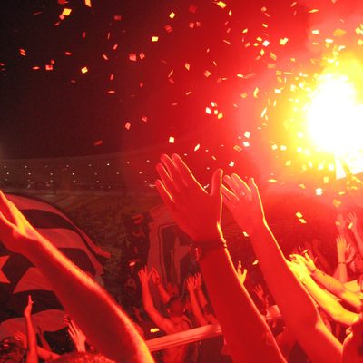 Red Lights, Confetti, and Cheering at a Stadium