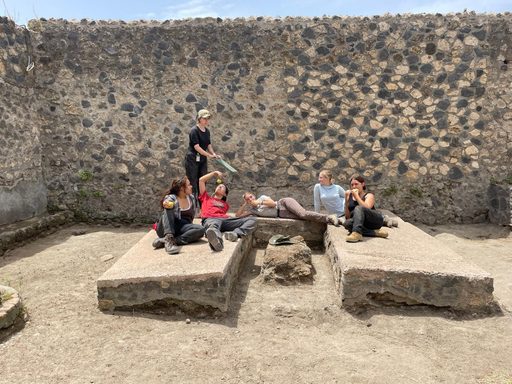 students resting on an ancient rune